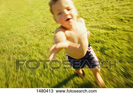 Boy runs through grass View Large Photo Image Stock Image - Boy runs through grass. Fotosearch