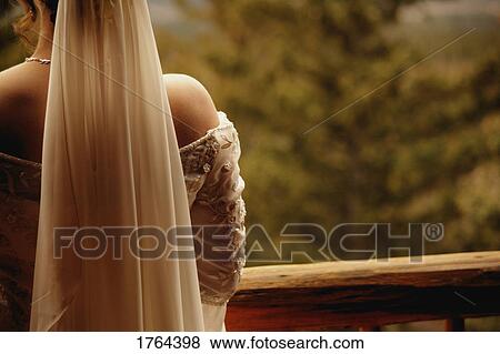 Stock Photo - Bride looks over balcony. Fotosearch