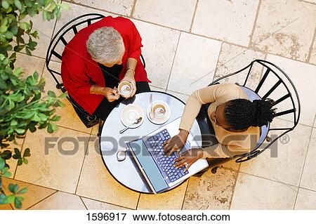Business meeting in a cafe View Large Photo Image Stock Photo - Business meeting in a cafe. Fotosearch