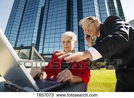 Business people working outside View Large Photo Image Stock Image - Business people working outside. Fotosearch