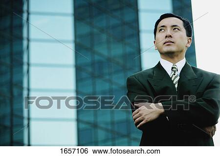 Businessman looks up View Large Photo Image Stock Photograph - Businessman looks up. Fotosearch