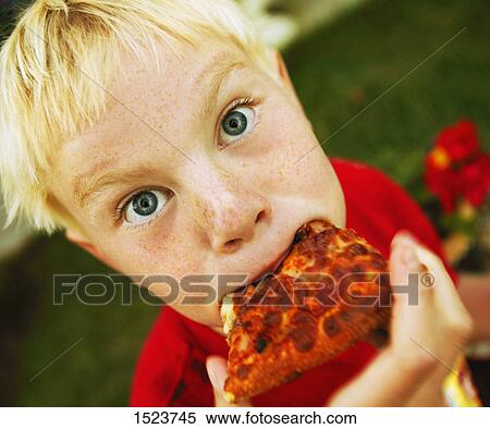 Stock Photography - Child eats pizza. Fotosearch