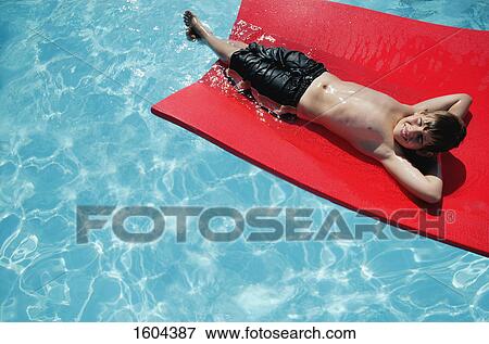 Stock Photo - Child floats on mat. Fotosearch