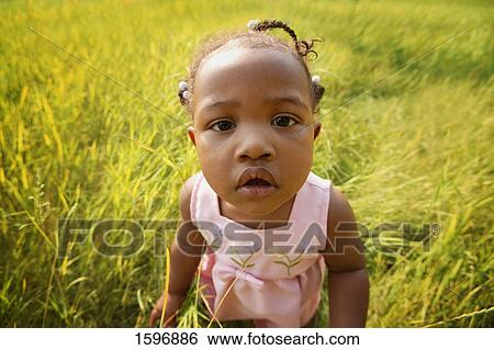 Child in a field View Large Photo Image Stock Photograph - Child in a field. Fotosearch