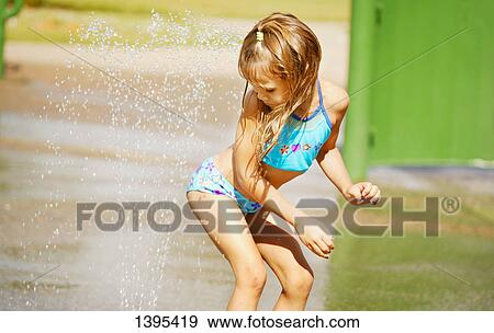 Child plays in sprinkler View Large Photo Image Stock Photo - Child plays in sprinkler. Fotosearch