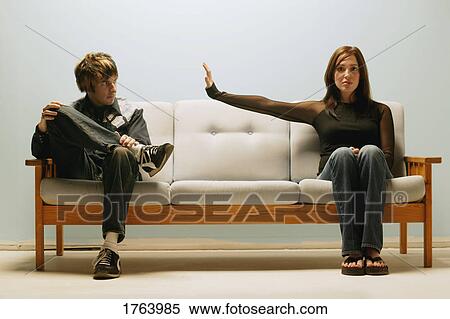 Couple sits on a couch View Large Photo Image Stock Photography - Couple sits on a couch. Fotosearch