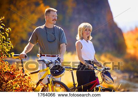 Couple stop to enjoy the view View Large Photo Image Stock Photograph - Couple stop to enjoy the view. Fotosearch