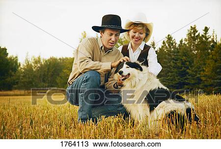Stock Image - Couple with pet. Fotosearch