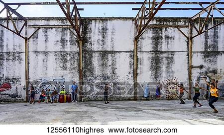 Stock Photograph - Cubans dancing in an old concrete building; Havana, Cuba. Fotosearch