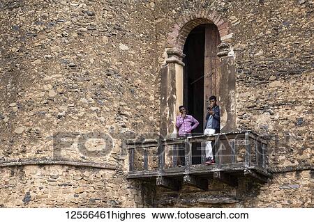 Ethiopian men on a balcony of Fasilides Castle, founded by Emperor Fasilides in the 17th century, Fasil Ghebbi (Royal Enclosure); Gondar, Amhara Region, Ethiopia View Large Photo Image Stock Photograph - Ethiopian men on a balcony of Fasilides Castle, founded by Emperor Fasilides in the 17th century, Fasil Ghebbi (Royal Enclosure); Gondar, Amhara Region, Ethiopia. Fotosearch