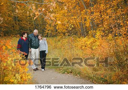 Family goes for a walk View Large Photo Image Stock Photograph - Family goes for a walk. Fotosearch