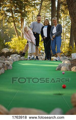 Stock Photo - Family goes mini golfing. Fotosearch