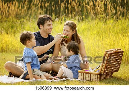 Stock Photo - Family having a picnic. Fotosearch