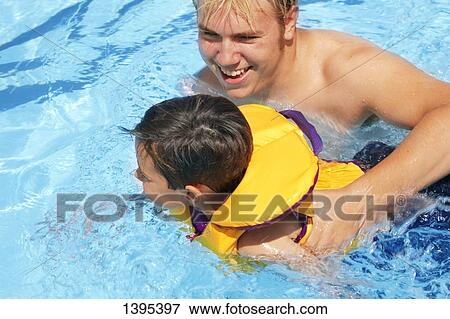 Father and child in pool View Large Photo Image Stock Photo - Father and child in pool. Fotosearch