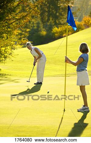 Stock Image - Female golfers. Fotosearch