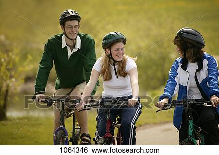 Stock Photograph - Friends cycling together. Fotosearch