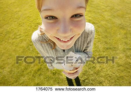 Girl eats ice cream View Large Photo Image Stock Photography - Girl eats ice cream. Fotosearch