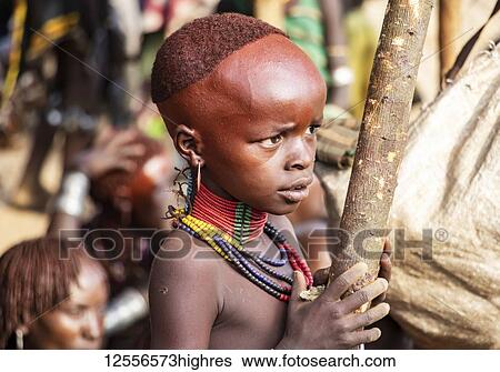 Stock Photograph - Hamer boy at a bull jumping ceremony, which initiates a boy into manhood, in the village of Asile; Aisle, Omo Valley, Ethiopia. Fotosearch