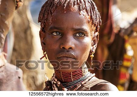 Stock Photograph - Hamer girl at a bull jumping ceremony, which initiates a boy into manhood, in the village of Asile; Aisle, Omo Valley, Ethiopia. Fotosearch