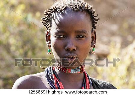 Stock Photograph - Hamer woman at a bull jumping ceremony, which initiates a boy into manhood, in the village of Asile; Omo Valley, Ethiopia. Fotosearch