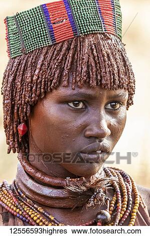 Hamer woman at a bull jumping ceremony, which initiates a boy into manhood, in the village of Asile; Omo Valley, Ethiopia View Large Photo Image Stock Photograph - Hamer woman at a bull jumping ceremony, which initiates a boy into manhood, in the village of Asile; Omo Valley, Ethiopia. Fotosearch