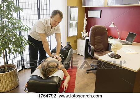 Stock Image - In a chiropractor's office. Fotosearch