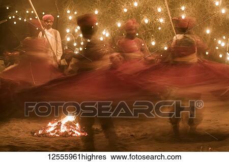 Stock Photograph - Indian dancers twirling around at a party; Rajasthan, India. Fotosearch