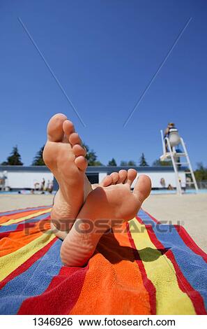 Stock Photograph - Laying down by a pool. Fotosearch