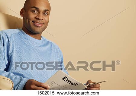Man reading a magazine View Large Photo Image Stock Photography - Man reading a magazine. Fotosearch