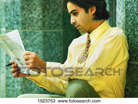 Man reading a paper View Large Photo Image Stock Image - Man reading a paper. Fotosearch