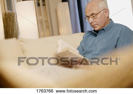 Stock Photograph - Man reads a book. Fotosearch
