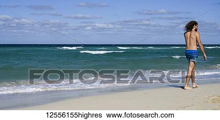Man walking on the beach of Santa Maria del Mar; Havana, Cuba View Large Photo Image Stock Photograph - Man walking on the beach of Santa Maria del Mar; Havana, Cuba. Fotosearch