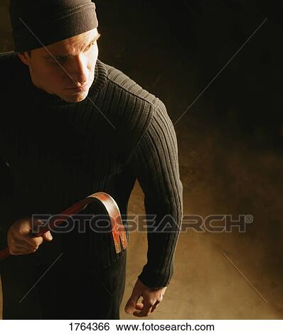 Stock Photograph - Man with a crow bar. Fotosearch