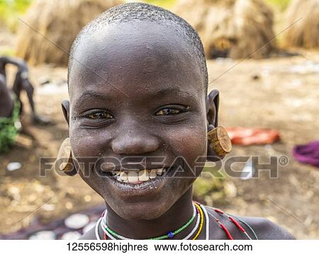 Mursi girl in a village in Mago National Park; Omo Valley, Ethiopia View Large Photo Image Stock Photograph - Mursi girl in a village in Mago National Park; Omo Valley, Ethiopia. Fotosearch