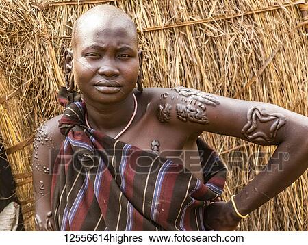Stock Photograph - Mursi woman in a village in Mago National Park, Omo Valley; Southern Nations Nationalities and Peoples' Region, Ethiopia. Fotosearch