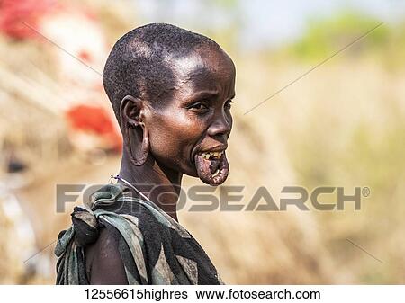 Mursi woman in a village in Mago National Park, Omo Valley; Southern Nations Nationalities and Peoples' Region, Ethiopia View Large Photo Image Stock Photograph - Mursi woman in a village in Mago National Park, Omo Valley; Southern Nations Nationalities and Peoples' Region, Ethiopia. Fotosearch