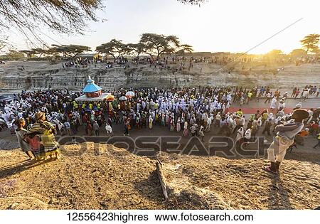 Stock Photograph - People in a Timkat procession during the Orthodox Tewahedo celebration of Epiphany, celebrated on January 19th; Bulbula, Oromia, Ethiopia. Fotosearch