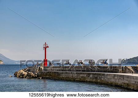 Stock Photograph - People resting in Dubrovnik's Old Port; Dubrovnik, Dubrovnik-Neretva County, Croatia. Fotosearch