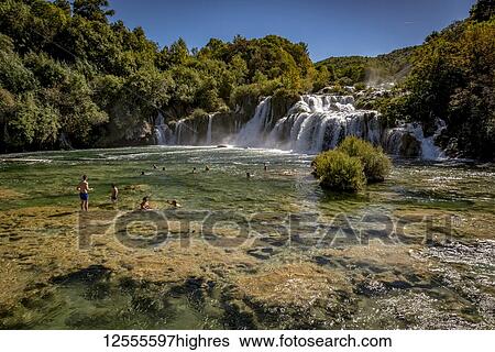 Stock Photograph - People swimming in the Krka River at the Krka waterfalls, Krka National Park; Croatia. Fotosearch