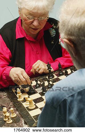 Stock Image - Playing a game of chess. Fotosearch