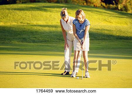 Stock Photo - Preparing for the putt. Fotosearch