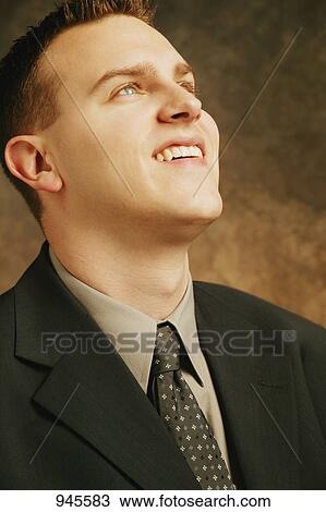 Professional man gazing upward View Large Photo Image Stock Image - Professional man gazing upward. Fotosearch
