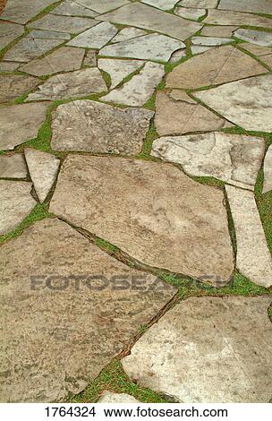 Picture - Rock path with grass growing between stones. Fotosearch