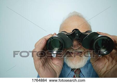 Picture - Senior looks through binoculars. Fotosearch