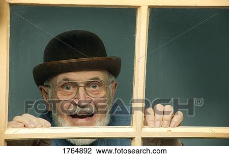 Senior peeks out window View Large Photo Image Stock Image - Senior peeks out window. Fotosearch