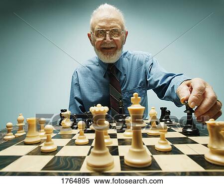 Stock Photography - Senior plays chess. Fotosearch
