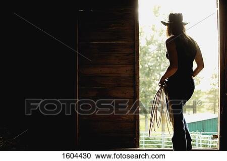 Stock Image - Silhouette of a cowgirl. Fotosearch