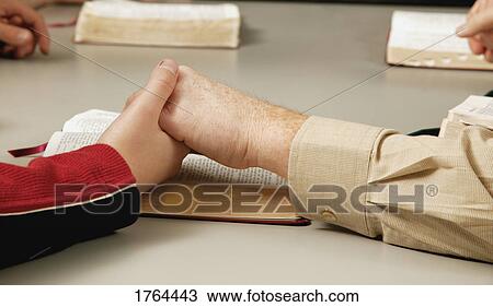 Stock Image - Small group prayer. Fotosearch