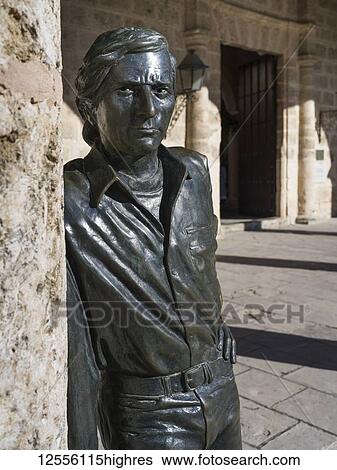 Statue of a man looking at the camera while leaning on a wall; Havana, Cuba View Large Photo Image Stock Photograph - Statue of a man looking at the camera while leaning on a wall; Havana, Cuba. Fotosearch