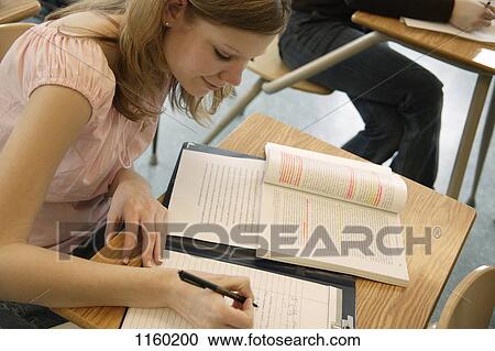 Student doing an assignment View Large Photo Image Stock Image - Student doing an assignment. Fotosearch